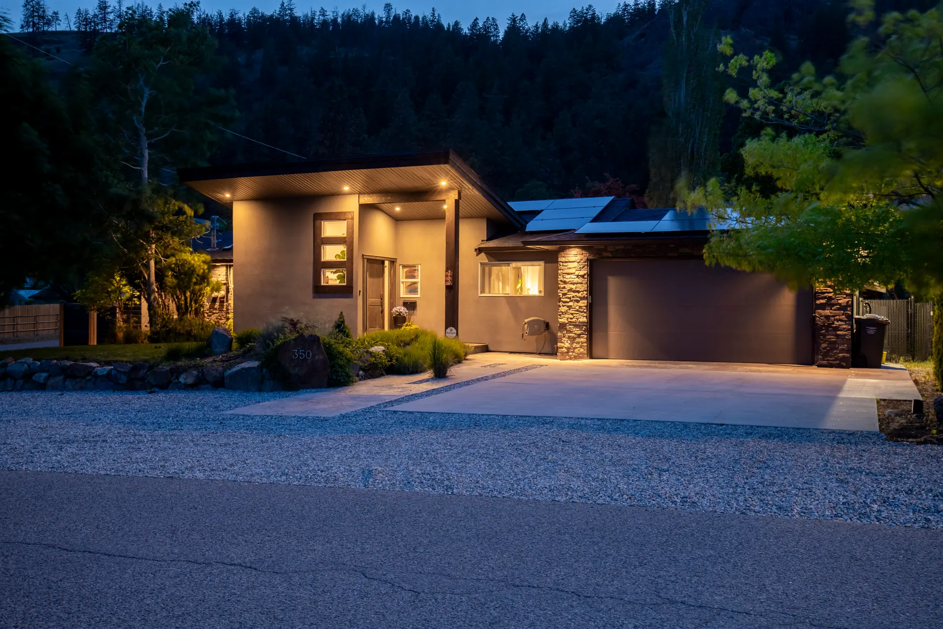 Twilight exterior, modern home with pool in Glenmore, Kelowna, BC. Real estate photography by Pixel Pro Productions.