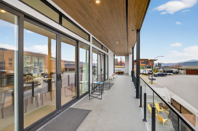 Covered deck, modern lake-view home in Lake Country, BC. Real estate photography by Pixel Pro Productions.