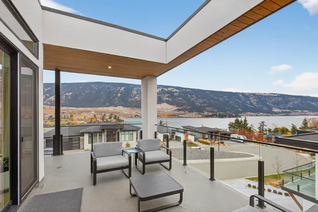 Deck lake view, modern lake-view home in Lake Country, BC. Real estate photography by Pixel Pro Productions.
