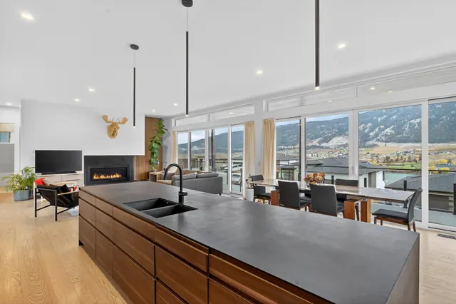 Kitchen living, modern lake-view home in Lake Country, BC. Real estate photography by Pixel Pro Productions.