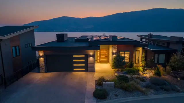 Twilight exterior, lake-view modern home in Lakestone, Lake Country, BC. Real estate photography by Pixel Pro Productions.