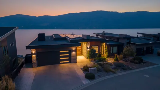 Twilight exterior lake view, lake-view modern home in Lakestone, Lake Country, BC. Real estate photography by Pixel Pro Productions.