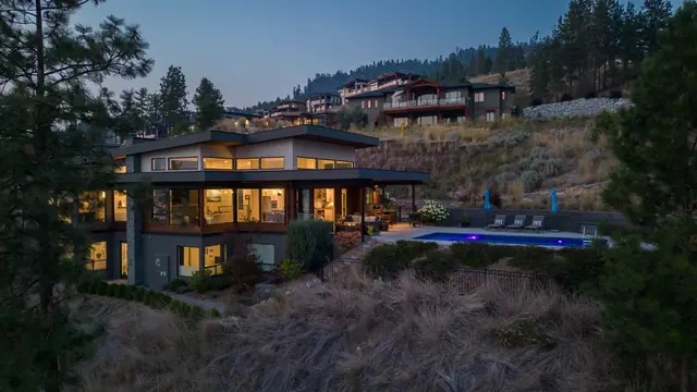 Aerial view twilight, luxury lake-view home in Lakestone, Lake Country, BC. Real estate photography by Pixel Pro Productions.