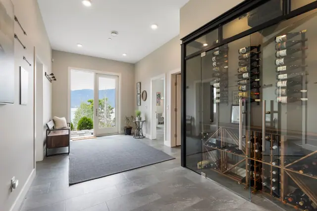 Entry wine wall, luxury lake-view home in Lakestone, Lake Country, BC. Real estate photography by Pixel Pro Productions.