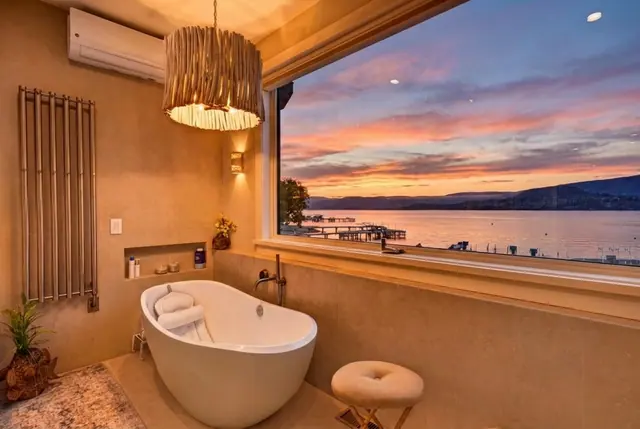 Ensuite soaker tub sunset, lakefront home renovation in Lower Mission, Kelowna, BC. Real estate photography by Pixel Pro Productions.