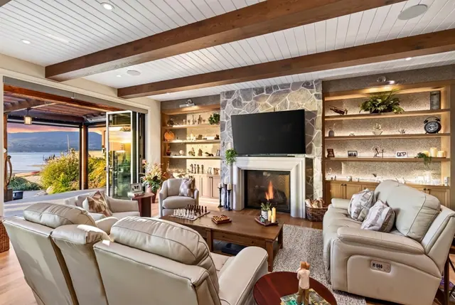 Living room lake view sunset, lakefront home renovation in Lower Mission, Kelowna, BC. Real estate photography by Pixel Pro Productions.