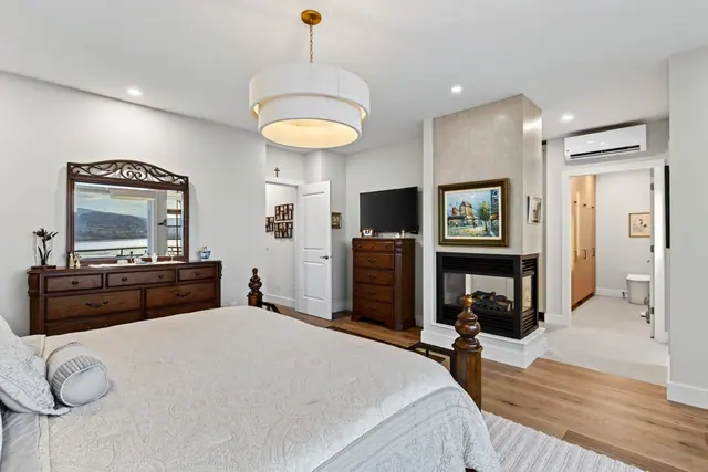 Primary bedroom fireplace, lakefront home renovation in Lower Mission, Kelowna, BC. Real estate photography by Pixel Pro Productions.