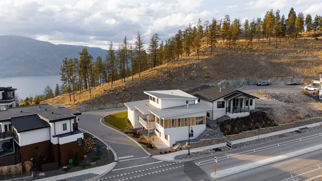 Aerial view lake view, modern new build in McKinley Beach, Kelowna, BC. Real estate photography by Pixel Pro Productions.