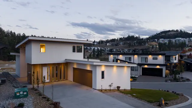Front exterior dusk, modern new build in McKinley Beach, Kelowna, BC. Real estate photography by Pixel Pro Productions.