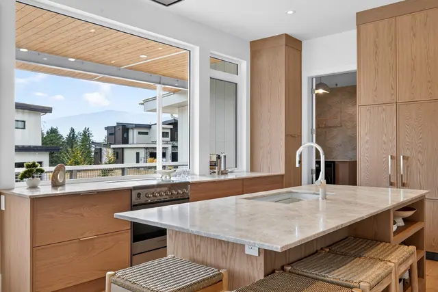 Kitchen island view, modern new build in McKinley Beach, Kelowna, BC. Real estate photography by Pixel Pro Productions.