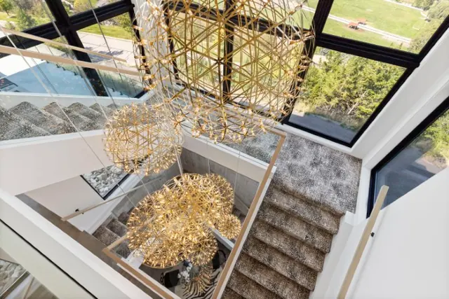 Chandelier staircase, luxury hillside estate in Vernon, BC. Real estate photography by Pixel Pro Productions.
