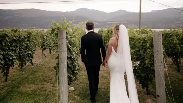 Vineyard stroll: Emily & Connor's wedding at 50th Parallel Estate, Lake Country. Still from the Pixel Pro wedding film.