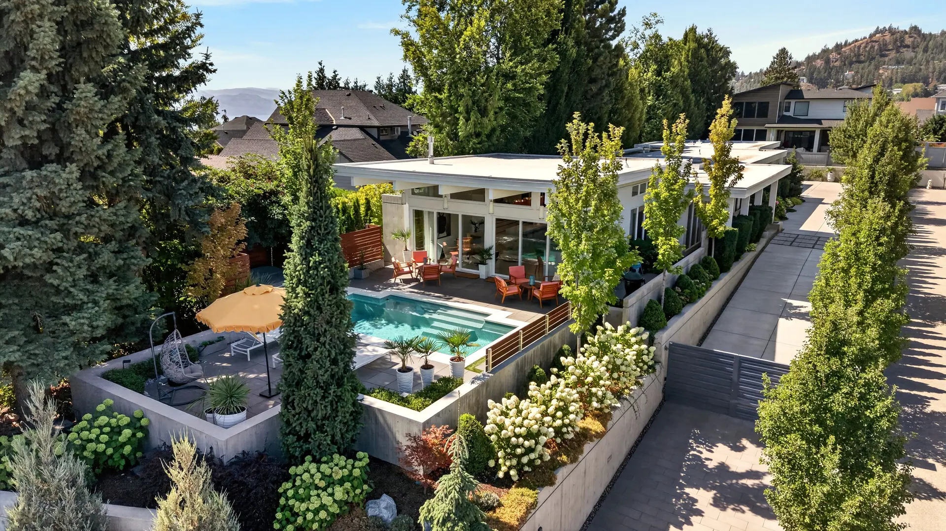 Aerial view backyard pool, mid-century modern home in West Kelowna, BC. Real estate photography by Pixel Pro Productions.
