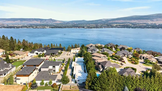 Aerial view lake view, mid-century modern home in West Kelowna, BC. Real estate photography by Pixel Pro Productions.
