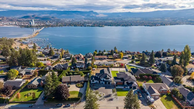 Aerial view lake view, new-build lake-view home in West Kelowna, BC. Real estate photography by Pixel Pro Productions.