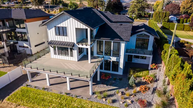 Aerial view rear deck, new-build lake-view home in West Kelowna, BC. Real estate photography by Pixel Pro Productions.